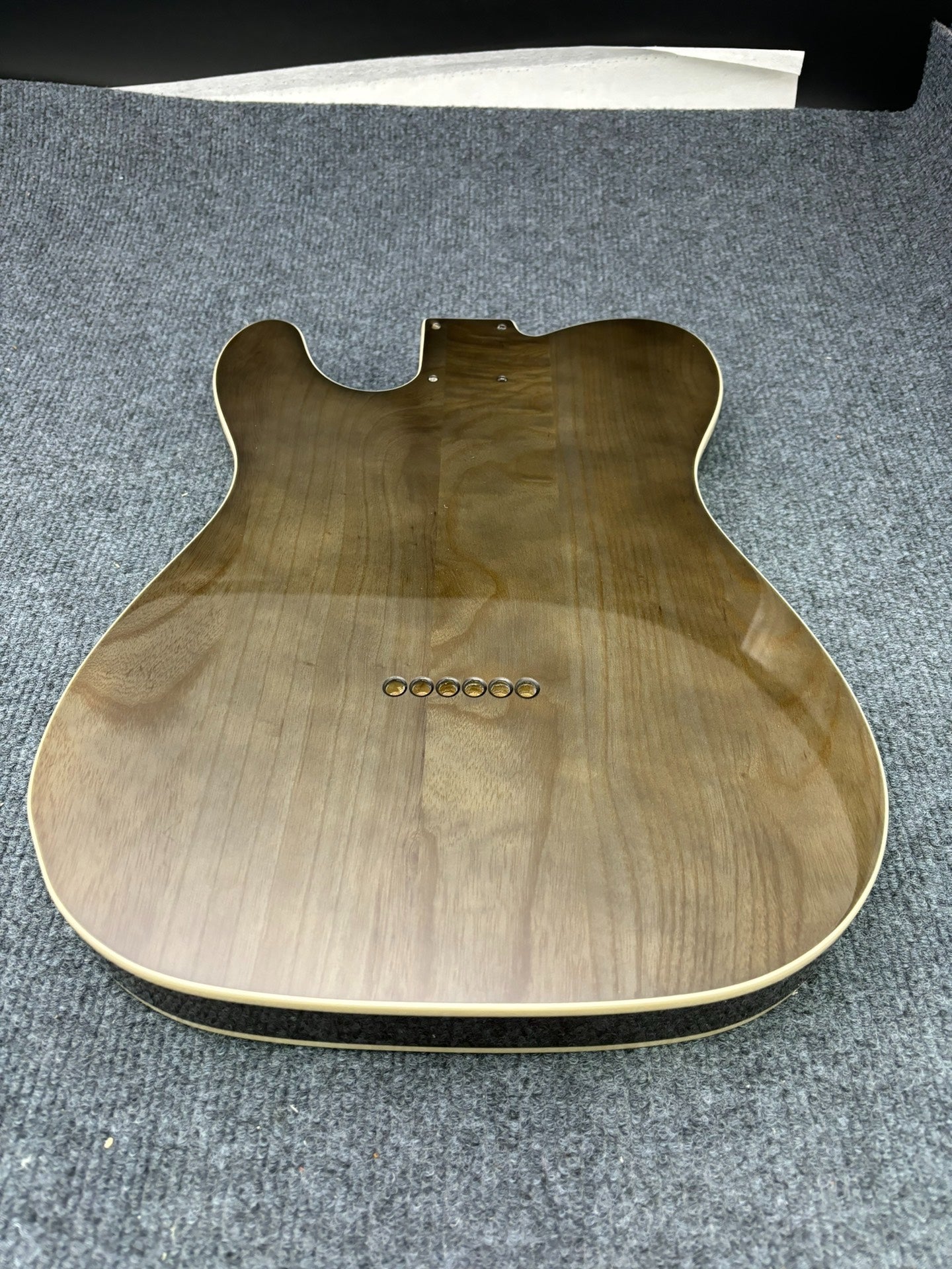 The semi-hollow body of TL electric guitar is 55.9mm wide and 17mm deep, with standard brass bridge and customized circuit.