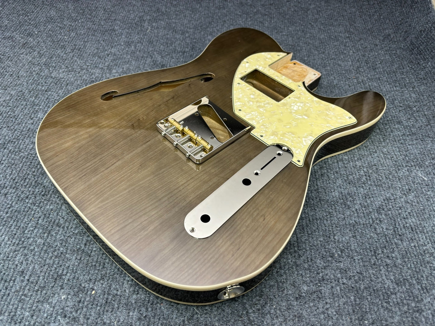 The semi-hollow body of TL electric guitar is 55.9mm wide and 17mm deep, with standard brass bridge and customized circuit.